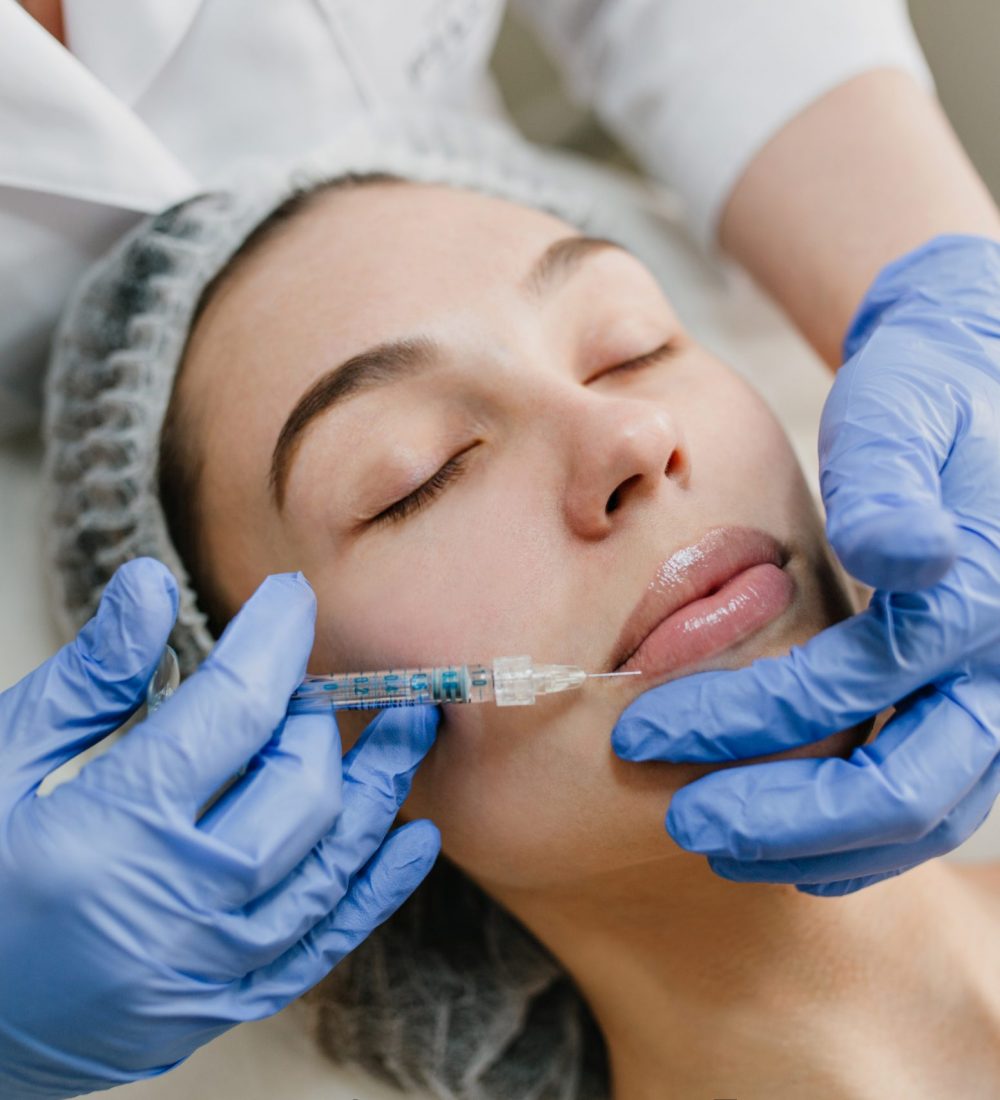Closeup portrait of beautiful woman during cosmetology therapy in beauty salon. Botox, lips, injecting, professional procedures, lifting, rejuvenation, modern devices, healthcare